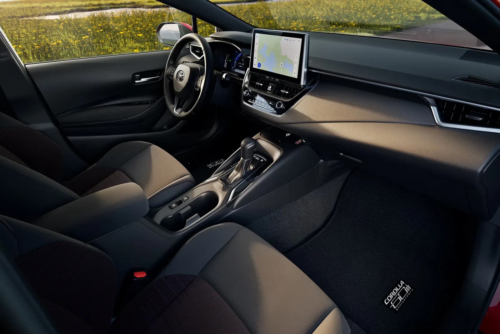 Toyota Corolla 60th Anniversary Edition interior with touchscreen and anniversary floor mat