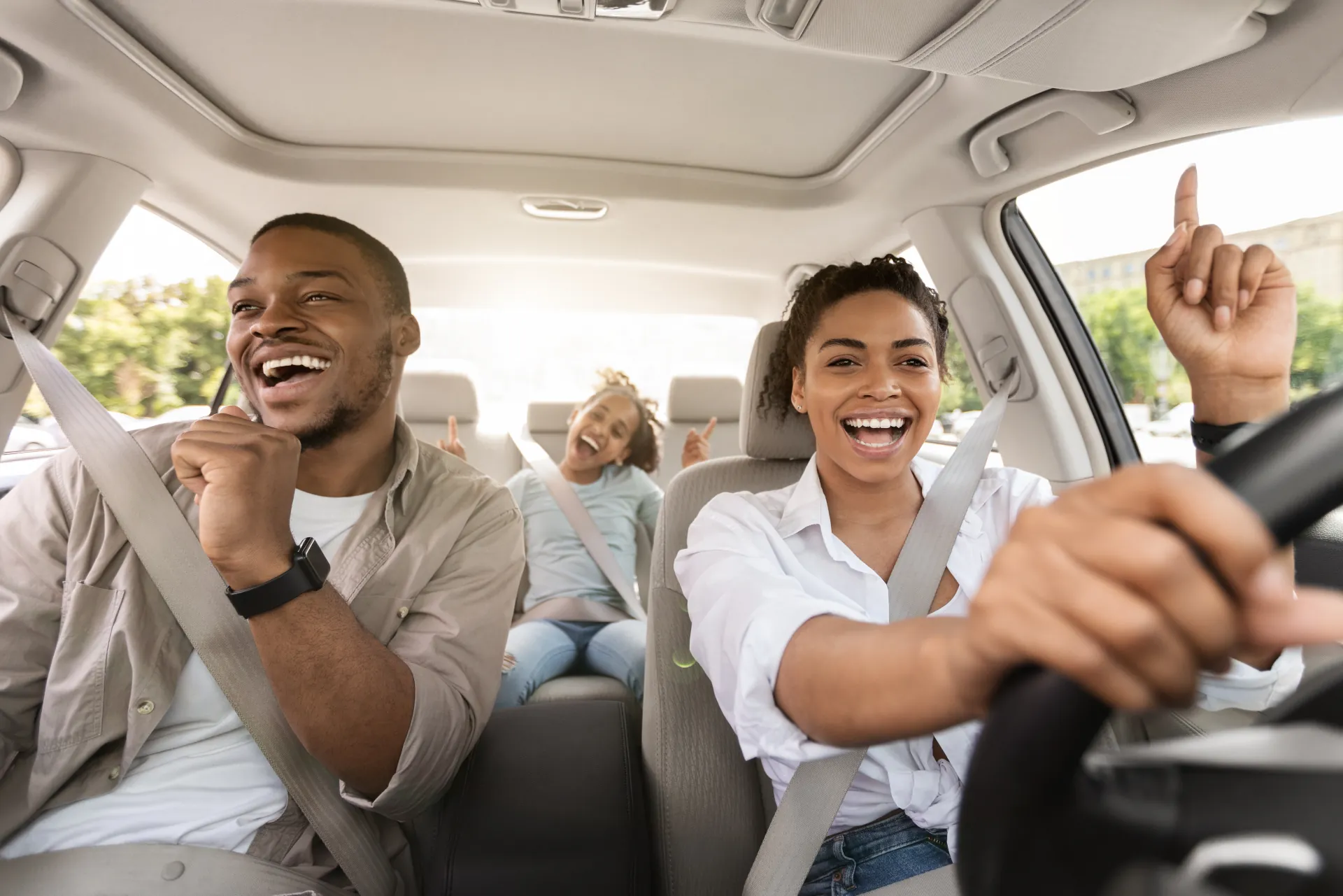 Happy family enjoying a road trip in their new car from Nalley Automotive